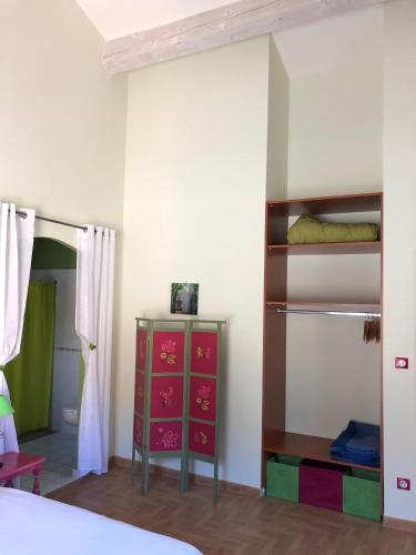 a bedroom with a bed and a dresser in a room at Domaine de Flo ADULT a partir de 16 ans in Saint-Jean-de-la-Blaquière