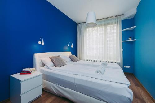 - une chambre bleue avec un grand lit et une fenêtre dans l'établissement ShortStayPoland Leszczyńska (B14), à Varsovie