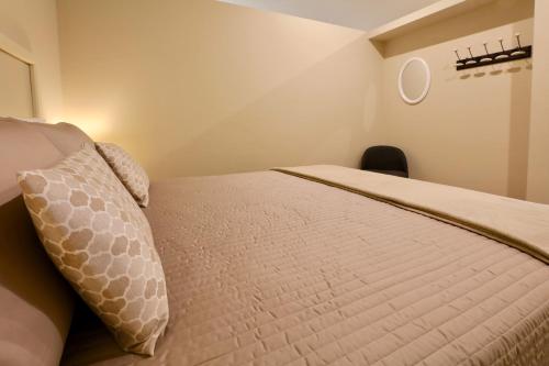 a bedroom with a bed with a pillow and a chair at LE SETTE VIE HOLIDAY HOMES in Monforte dʼAlba