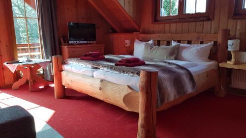 a bedroom with a large bed in a cabin at Naturtraum Georgshöhe in Thale