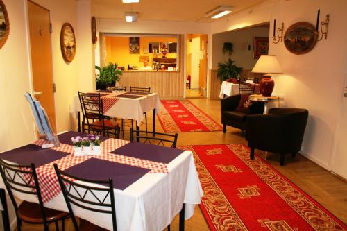 a dining room with tables and chairs in a room at Barents Hotell in Kirkenes