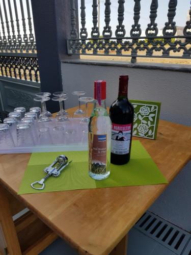 a table with two bottles of wine and glasses at B&B "Villa Alegria", Tarrafal in Tarrafal