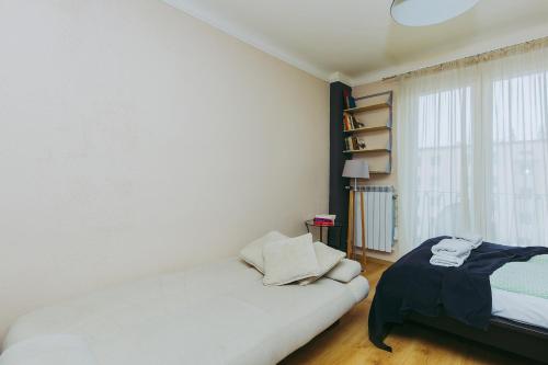 a white room with a bed and a window at ShortStayPoland Leszno (B53) in Warsaw