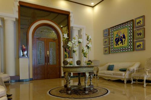 a living room with a door and a table at Faletti's Hotel Lahore in Lahore