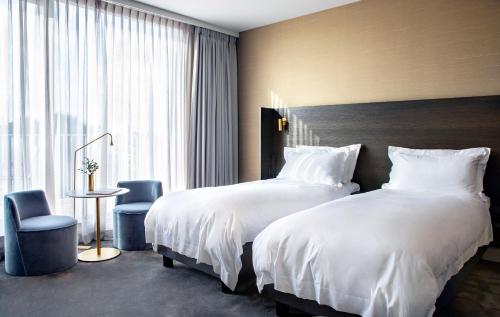 a hotel room with two beds and a window at Pillows Grand Boutique Hotel Reylof Ghent in Ghent