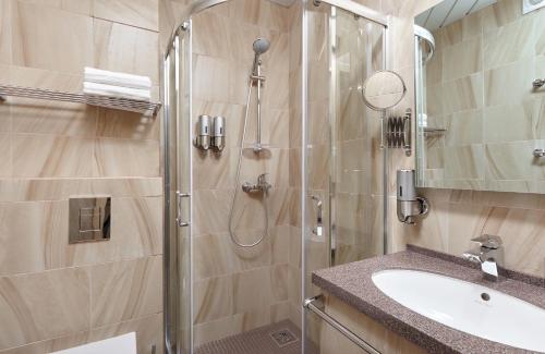 a bathroom with a shower and a sink at Granat Hotel in Nizhny Novgorod