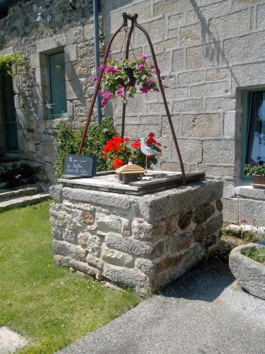 a flower pot on top of a stone wall at Le Domaine de Kerlys in Briec