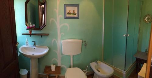 a bathroom with a sink and a toilet and a shower at Camere e accoglienza LA CASA DELLA NONNA in Borzonasca