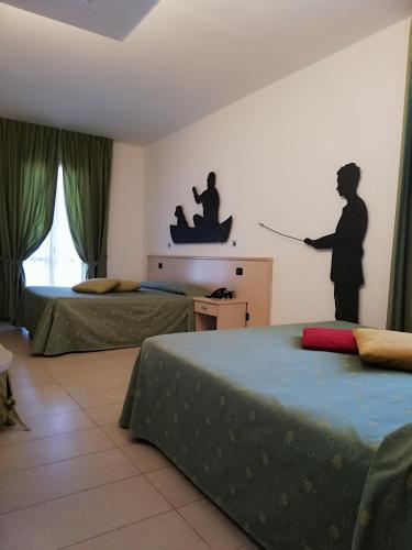 Postel nebo postele na pokoji v ubytování Hotel Fioroni