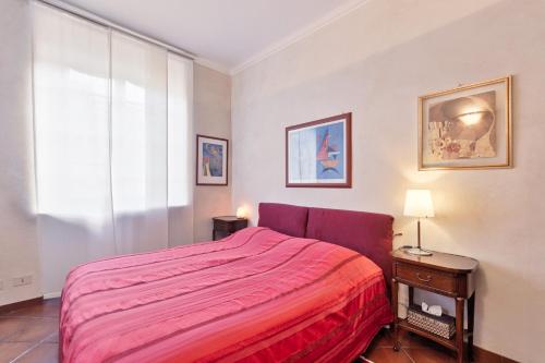 ein Schlafzimmer mit einem roten Bett und einem Fenster in der Unterkunft Arsenale Art Apartment in Turin