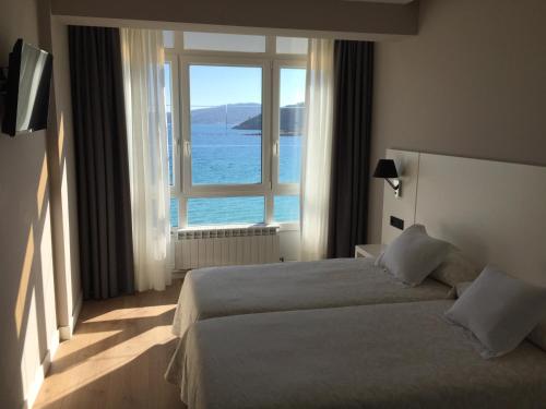 A bed or beds in a room at Hotel La Cruz