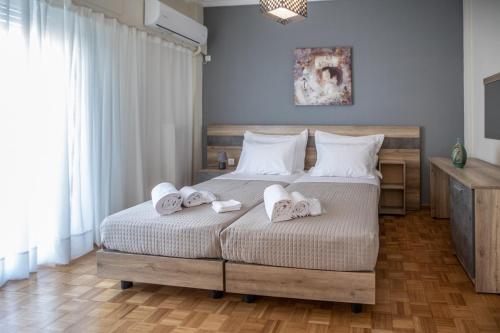 a bedroom with two beds with towels on them at PARADISE APARTMENT IN PIRAEUS CENTRE in Piraeus