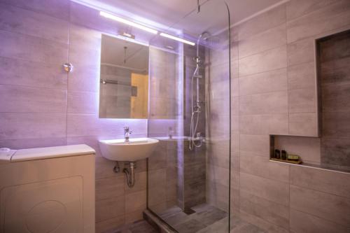 a bathroom with a shower and a sink and a shower at PARADISE APARTMENT IN PIRAEUS CENTRE in Piraeus