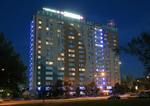 a large building with blue lights on it at night at Zvezdnaya Hotel in Moscow