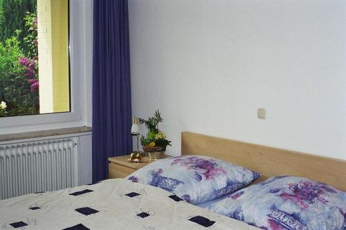 a bedroom with a bed with two pillows on it at Ferienhaus Alte Straße in Bad Zwischenahn