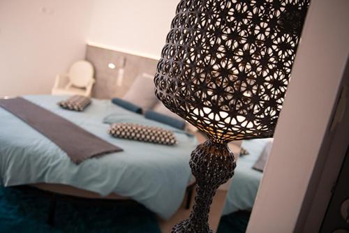 a bedroom with a bed with a lamp on it at Mise en Scène in Aumelas