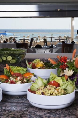 a table with several plates of food on it at Shams Prestige Abu Soma (Adults Only) in Hurghada