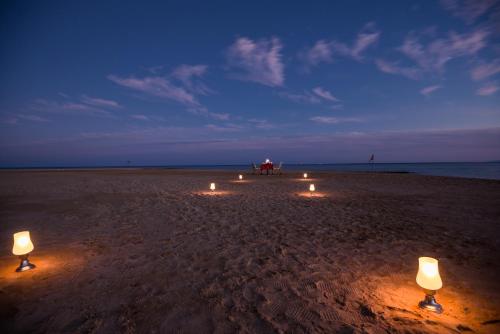 a group of lights on a beach at night at Shams Prestige Abu Soma (Adults Only) in Hurghada