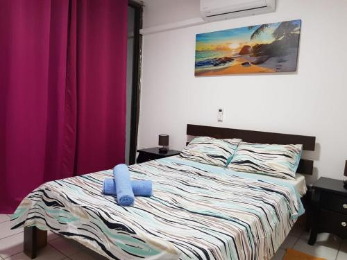 a bedroom with a bed with a blue stuffed animal on it at Lev Eilat Apartments 5 in Eilat