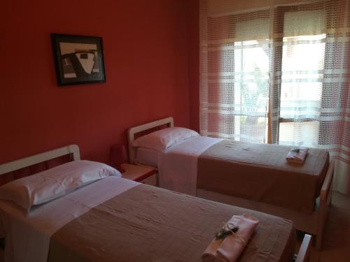 a bedroom with two beds and a window at Residence MareVerde in Senigallia