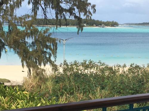 a view of the beach from the balcony of a house at Villa Bella Charming Beachfront Guesthouse in Blue Bay