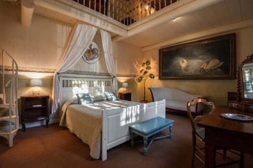 a bedroom with a white bed and a table at Casa Schlatter in Florence