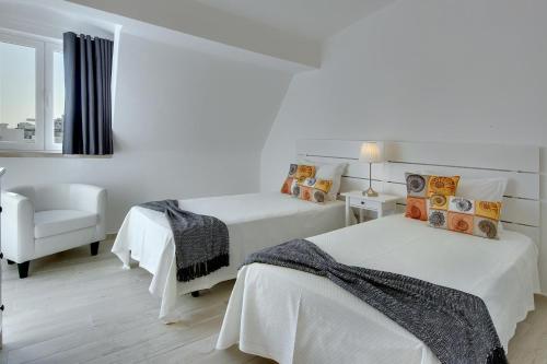 เตียงในห้องที่ Apartamentos Tucha