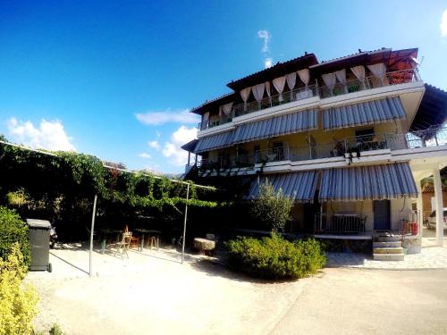 a large building with vines on the side of it at Rexhos Studios in Himare