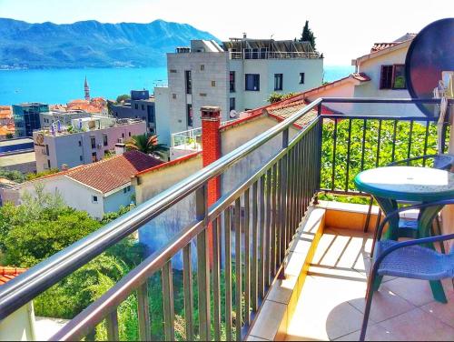 a balcony with a table and a view of a city at Apartmani Cupic in Budva