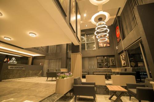 a restaurant with chairs and tables and a chandelier at Prusias Otel in Bursa