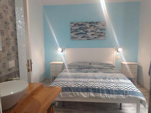 a bedroom with a bed and a sink and a tub at Confort By The Sea in Vico Equense