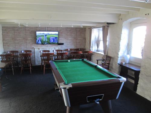 a pool table in the middle of a room with ahibition at Wentworth arms in Malton