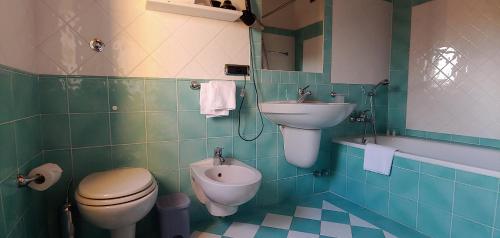 a bathroom with a sink and a toilet and a bidet at Torrebianca Tuscany in Rignano sullʼArno