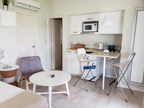 a small kitchen with a table and chairs in a room at Las Eduardas in La Paloma