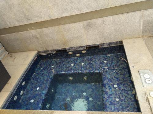 an overhead view of a swimming pool in a building at Angsana Oasis Spa & Resort in Yelahanka