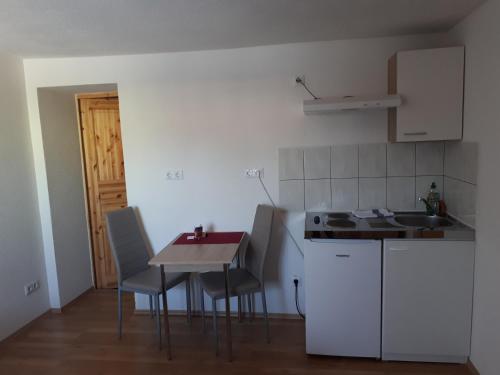 a kitchen with a table and chairs and a counter top at Gästehaus Apartments B & B27 und Pension Waldhorn in Rottweil