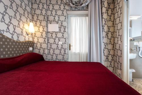 Ένα ή περισσότερα κρεβάτια σε δωμάτιο στο Hotel Ca' Nobile Corner