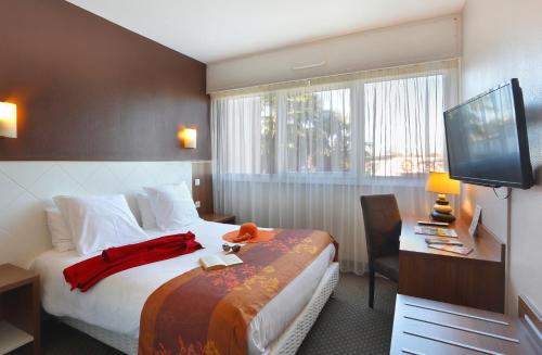 Säng eller sängar i ett rum på Cit'Hotel Atlantic Hotel