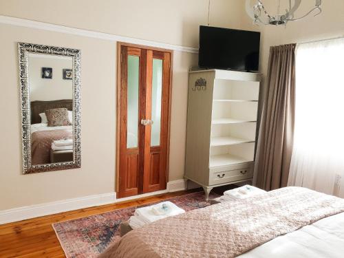 Ένα ή περισσότερα κρεβάτια σε δωμάτιο στο Bauhenia Guesthouse