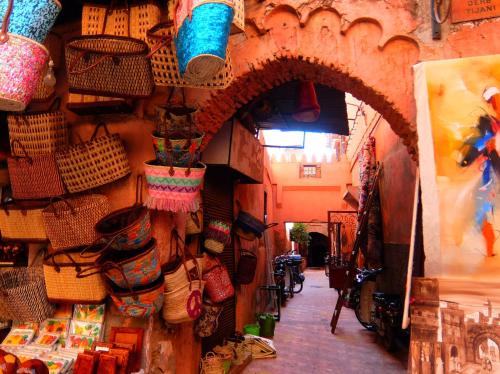 a shop with baskets on the wall of a store at Riad Les Nuits de Marrakech in Marrakech