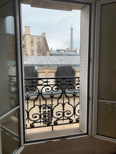 a view through a window of a building with windows at Eiffel Tower view Residence in Paris