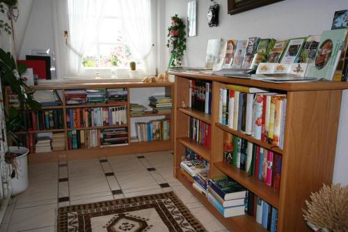 a room with two book shelves filled with books at Ewigleben, Landhaus Gartenstraße in Bispingen