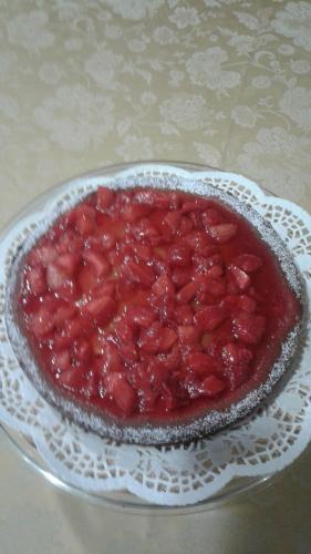 a strawberry pie on a plate on a table at Residence Delta in Rovigo