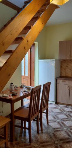 a kitchen with a table and chairs in a room at Atmatas in Bernāti