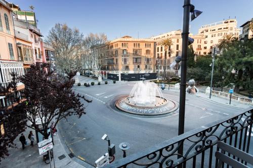a fountain in the middle of a street with buildings at Borne Suites TI by MallorcaSuites in Palma de Mallorca