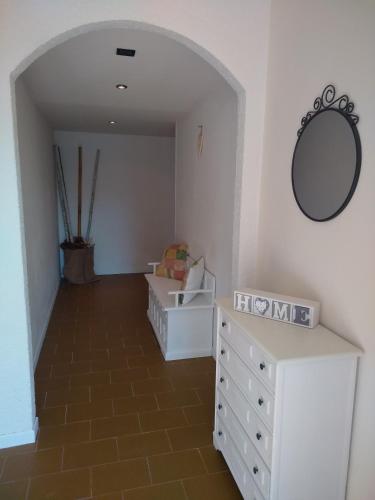 a room with a white dresser and a mirror at Casa Lory in Marone