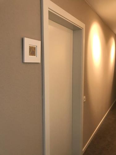 a door to a hallway with a picture on the wall at Hotel Garni Villa Rosengarten in Überlingen