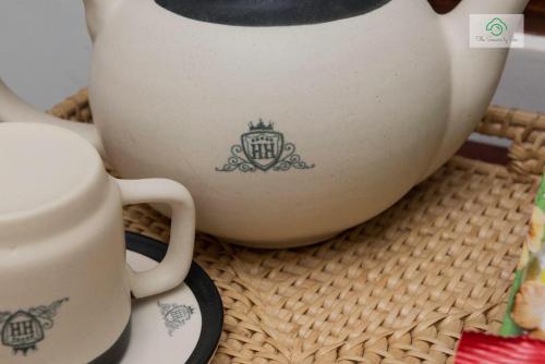 a coffee pot with a crown on it sitting on a basket at Headman House Antique Villa - Ahangama in Ahangama