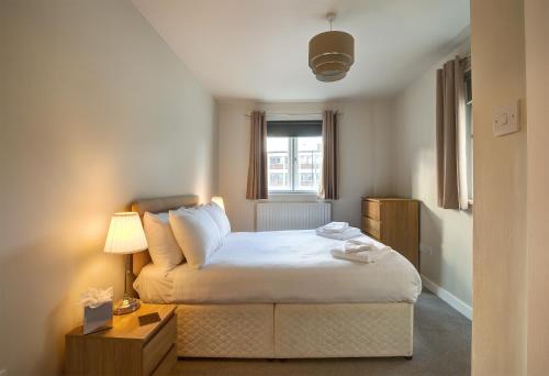 a small bedroom with a bed and a window at The Royal Foundation of St Katharine in London