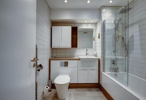 a bathroom with a toilet and a sink and a shower at The Royal Foundation of St Katharine in London